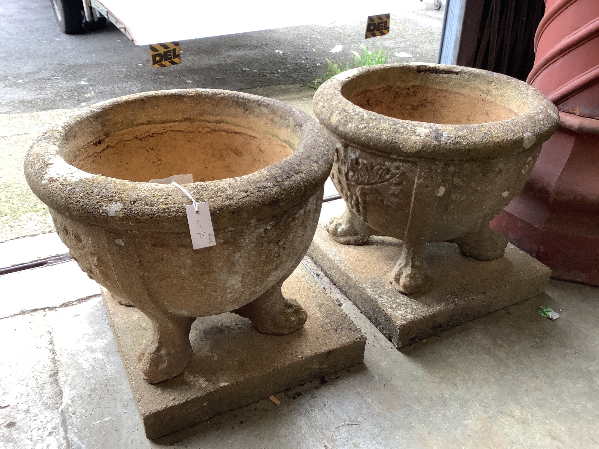 A pair of 19th century circular reconstituted stone garden planters on square plinth bases, diameter 60cm, height 54cm